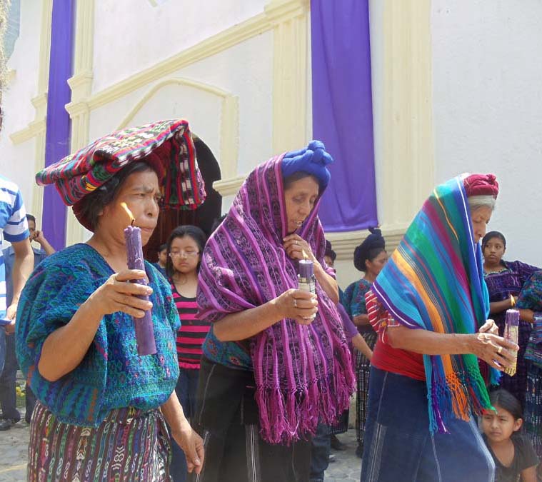 Indigenous Women holding candles during Semana Santa in Santa Catarina Palopo